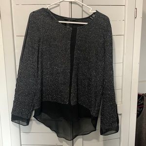 Black top with sheer black accents on sleeves, down the front, and back. Size M